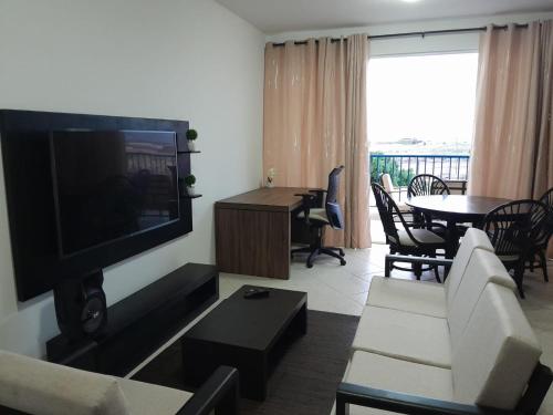 a living room with a couch and a tv and a table at Solaren Apartments Boavista in Sal Rei