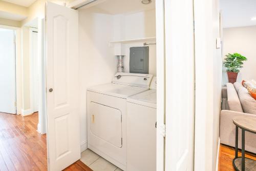 a white laundry room with a washer and dryer at Cozy 3 Bedroom Min to National Mall Great Location and Free Parking in Arlington