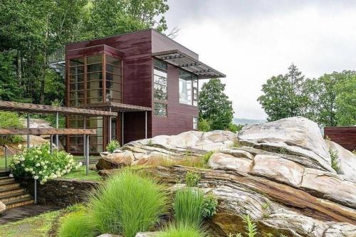 a house on top of a large rock at Magical Country Retreat in the Berkshires in Great Barrington