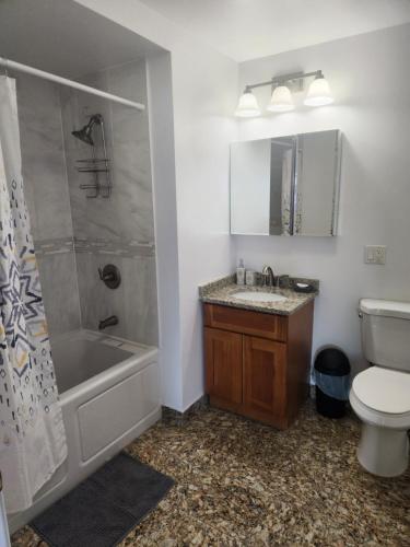 a bathroom with a toilet and a sink and a shower at Spacious 1BR Apt Mins to NYC in Union City