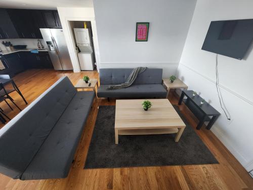 a living room with a couch and a coffee table at Spacious 1BR Apt Mins to NYC in Union City
