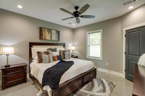 a bedroom with a bed with a ceiling fan at Chic Arkansas Retreat with Patio, Grill and Fire Pit! in Fairfield Bay