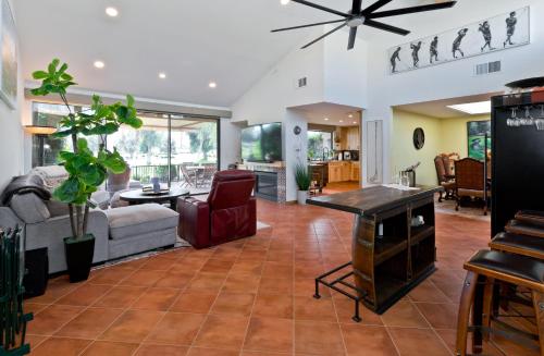 a living room with a couch and a table at Spectacular condo with private golf privileges includes golf cart on Monterey Country Club !! in Palm Desert