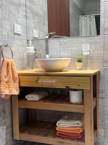 a bathroom with a counter with a bowl sink on it at Depto acogedor, moderno y espacioso in Rosario