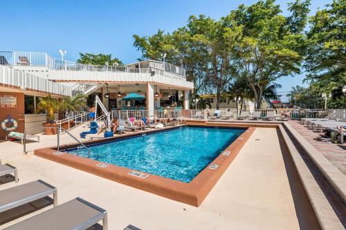 a swimming pool at a resort with lounge chairs at Fort Lauderdale Beach Resort by Vacatia in Fort Lauderdale