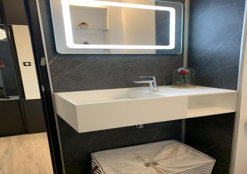 a bathroom with a white sink and a mirror at L'Étoile de Mer - Étretat in Le Havre