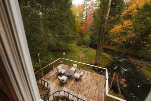 an aerial view of a deck with a table and chairs at Enchanting River- Water Front A-Frame Cabin in Yulan