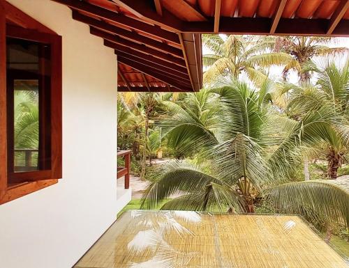 a view of a patio with palm trees from a house at Kíria's Village Beach House in Marau