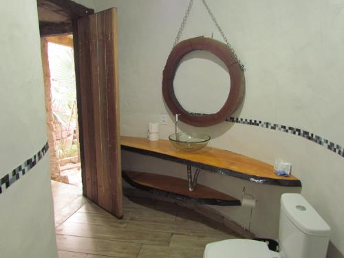 a bathroom with a mirror and a toilet at Boutique Hotel Casa de Guimarães in Chapada dos Guimarães
