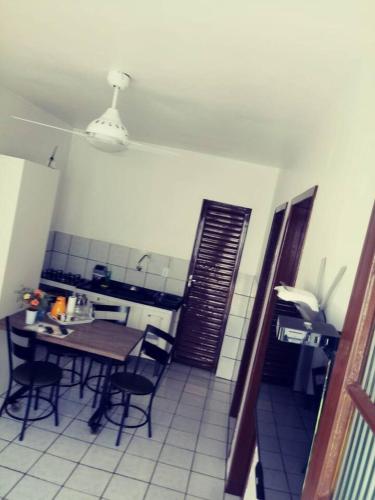 a kitchen with a table and chairs in a room at Apto Prático n.07 in Cascavel