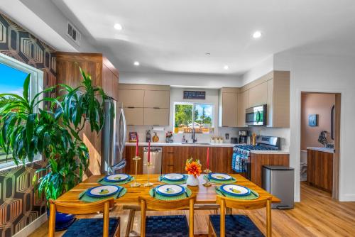 a kitchen with a wooden table with four chairs and a dining room at Stylish Sherman Oaks Townhouse 3bed + 3.5bath All Master Suites in Los Angeles