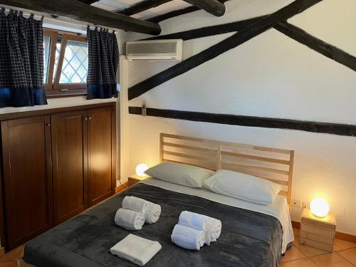 a bedroom with a bed with two towels on it at Casa Vacanze La Riserva Maccarese in Maccarese