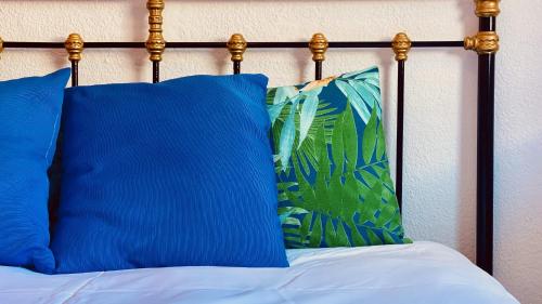 a blue pillow sitting on top of a bed at Nice flat with terrace in Puerto Rico in Puerto Rico de Gran Canaria