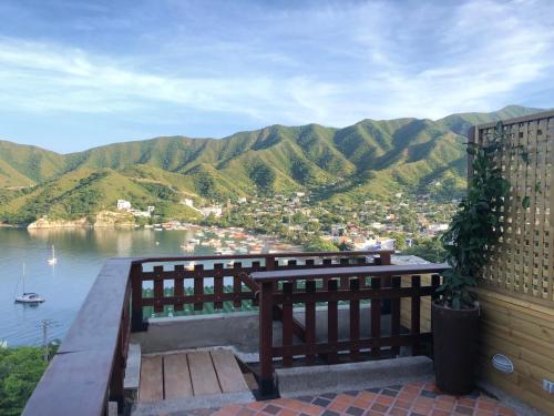 a bench sitting on a balcony overlooking a body of water at Cabañas Annapurna in Taganga