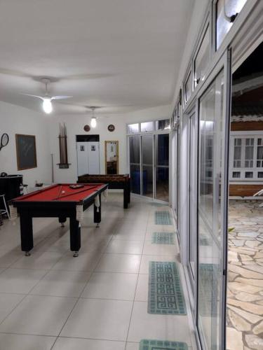 a room with a ping pong table in it at Linda casa em condomínio fechado para temporada. in Itatiba
