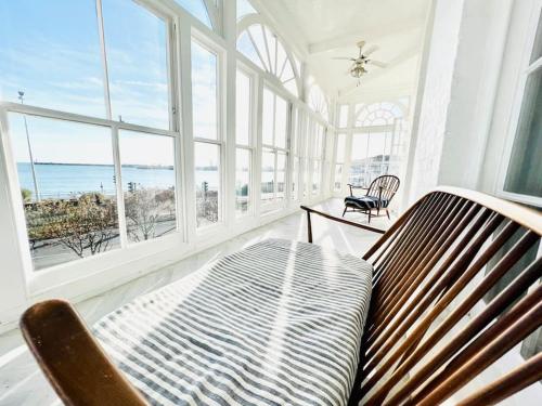 a living room with a bench and a view of the ocean at Flat 4 Marine Parade House, 1 East Cliff- Next to Dover Port, White Cliffs, Beach, Castle in Dover