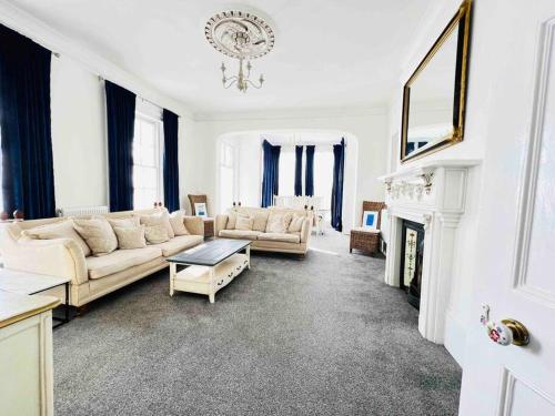 a living room with two couches and a fireplace at Marine Parade House F4 Next to Dover Port, White Cliffs, Beach, Castle in Dover