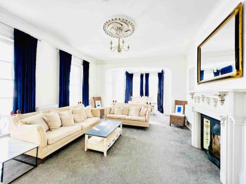 a living room with two couches and a fireplace at Flat 4 Marine Parade House, 1 East Cliff- Next to Dover Port, White Cliffs, Beach, Castle in Dover