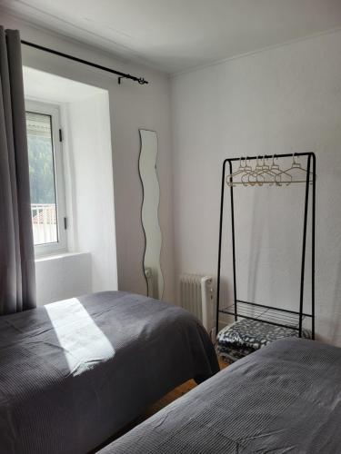 a bedroom with two beds and a mirror on the wall at Free Spirit in Vale do Torno