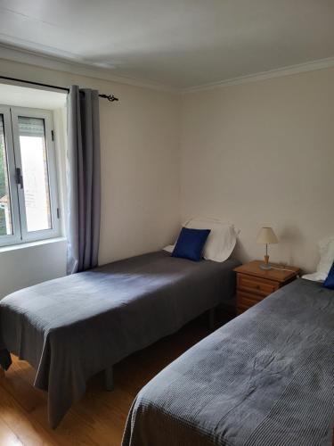 a bedroom with two beds and a window at Free Spirit in Vale do Torno