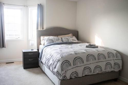 a bedroom with a large bed and a window at Beautiful Home 5 Minutes from Ottawa Airport in Ottawa