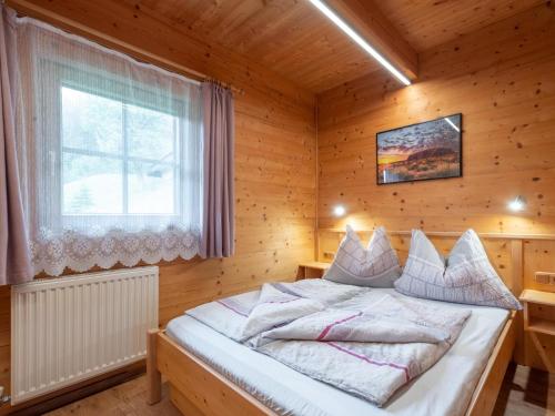 a bedroom with a bed in a wooden room at Schüttbach in Wagrain