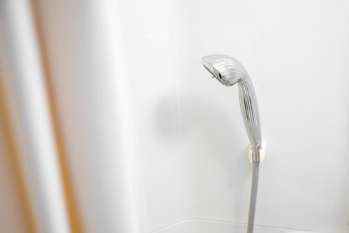 a shower head in front of a window at Super Hotel Yamagataeki Nishiguchi Hot Spring in Yamagata