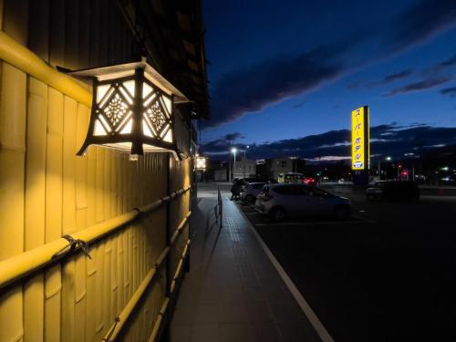 a light on the side of a building at night at Super Hotel Yamagataeki Nishiguchi Hot Spring in Yamagata