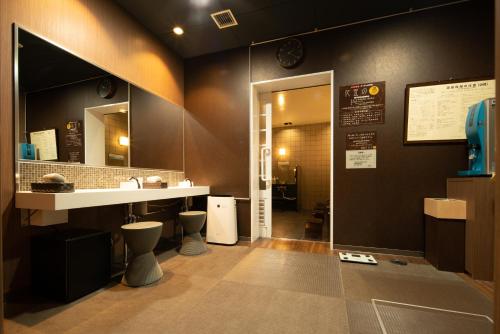 a bathroom with a sink and two toilets at Super Hotel Yamagataeki Nishiguchi Hot Spring in Yamagata