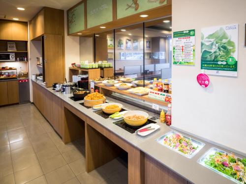 a buffet line in a restaurant with food at Super Hotel Yamagataeki Nishiguchi Hot Spring in Yamagata