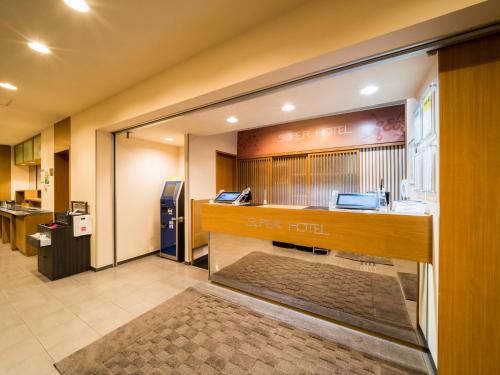 a store lobby with a keep tofu sign on the wall at Super Hotel Yamagataeki Nishiguchi Hot Spring in Yamagata