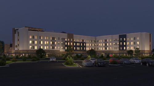 a large building with cars parked in a parking lot at Staybridge Suites Eastvale - Norco by IHG in Eastvale