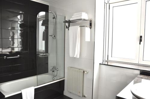 a bathroom with a shower and a sink at Hotel Crunia I A Coruña in A Coruña