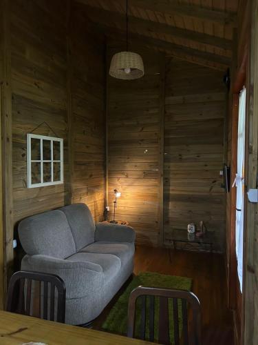 a living room with a couch and a table at CASA GAMBOA BEACH in Garopaba
