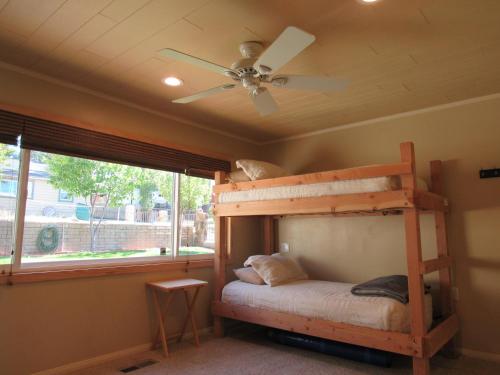 a bedroom with a bunk bed and a ceiling fan at Smith Lakefront Hideaway in Big Bear Lake