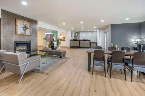 a living room with a dining table and a fireplace at Best Western PLUS Peppertree Airport Inn in Spokane