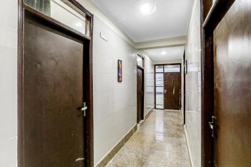 a corridor with a door in a building at Collection O AP Grand in Noida