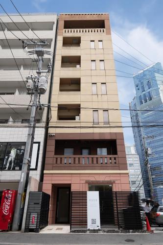 a tall building with a gate in front of it at RIVER CENTRAL HIROSHIMA in Hiroshima