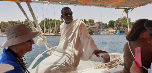 a man on a boat with two people on it at Adad Noubian House in Aswan
