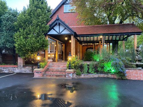 a house with a pond in front of it at Chester Court Hotel in Chester