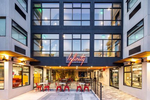a restaurant with red tables and chairs in front of a building at Infinity Hotel San Francisco, Tapestry Collection by Hilton in San Francisco