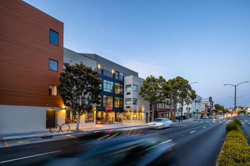 a car driving down a street in front of a building at Infinity Hotel San Francisco, Tapestry Collection by Hilton in San Francisco