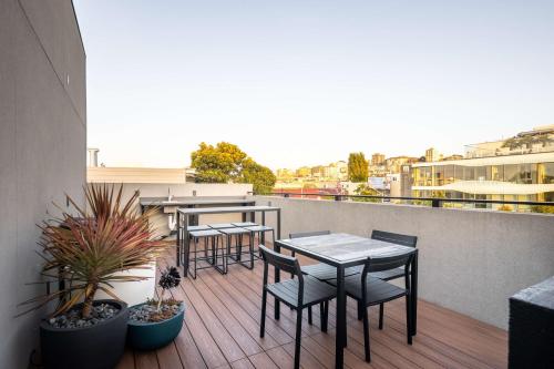 a patio with tables and chairs on a balcony at Infinity Hotel San Francisco, Tapestry Collection by Hilton in San Francisco