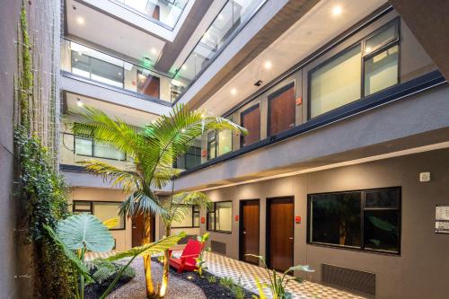 a building with a courtyard with a palm tree in it at Infinity Hotel San Francisco, Tapestry Collection by Hilton in San Francisco