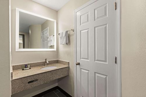 a bathroom with a sink and a mirror at Sleep Inn in Lithonia