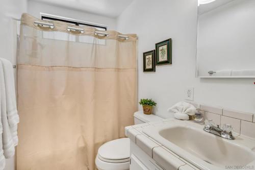 a white bathroom with a toilet and a sink at The Bungalow Partial Home Rental in Julian