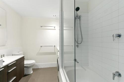 a white bathroom with a shower and a toilet at U4/51 Luxe Chic in Perth