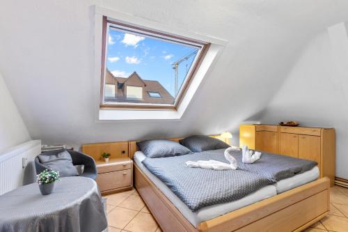 a small bedroom with a bed and a window at Family&Friends 2 in Ludwigshafen