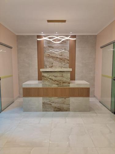 a lobby with a fountain in the middle of a building at Becker Center Hotel in Querencia