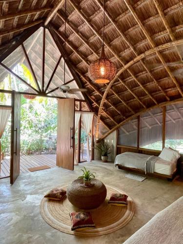 a large room with a bed and a large ceiling at Gitana del Mar Beach Retreat in Buritaca